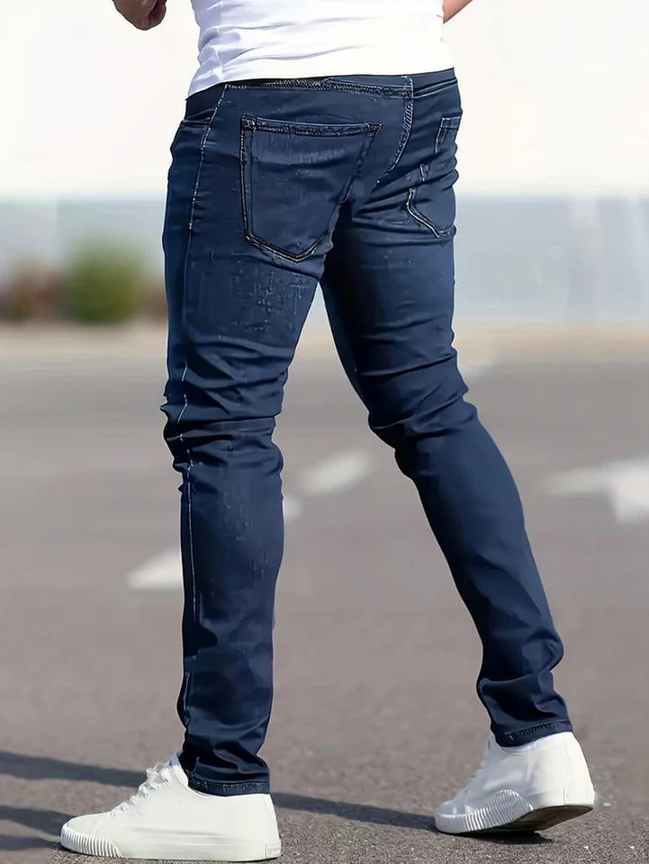 A set of three men's slim-fit jeans in multiple colors, including black, dark blue, and light blue, designed to fit the body sha