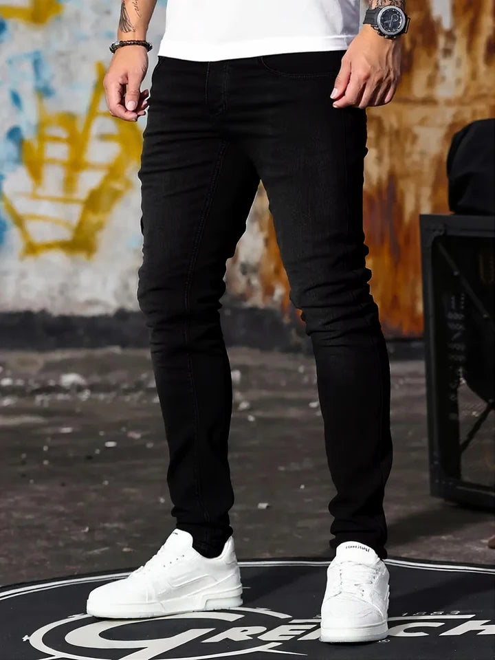 A set of three men's slim-fit jeans in multiple colors, including black, dark blue, and light blue, designed to fit the body sha